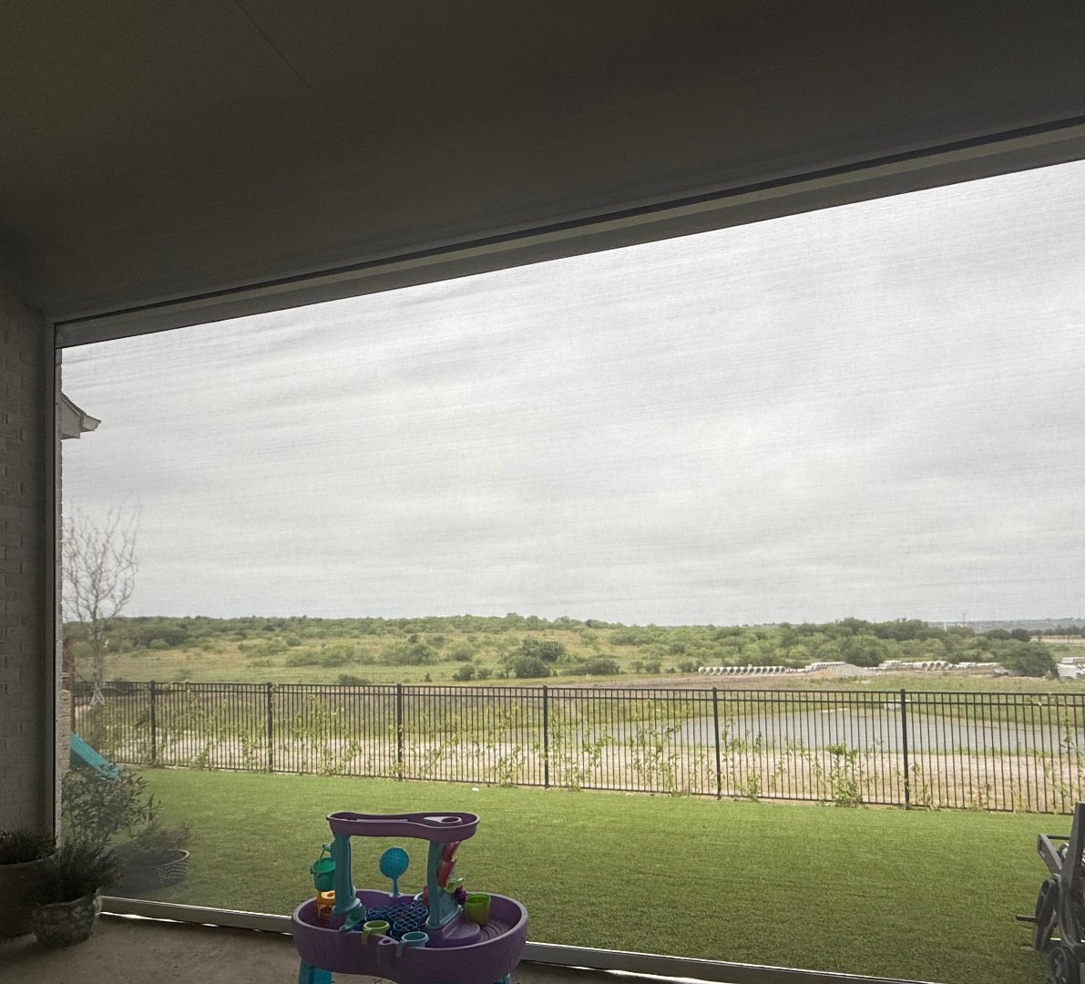 UVtex solar screen fabric installed on a DFW patio, soft light filtering through the weave