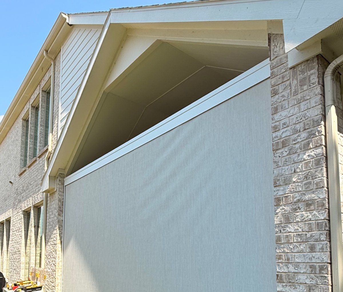 Color-matched aluminum cassette housing a motorized shade, with the fabric roll edge below